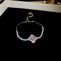 Bracelet élégant plaqué or avec fleur de trèfle en zircon rose et chaîne à glissière réglable. - Or-Rose