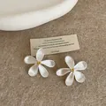 Detail shot of silver flower stud earrings with gold stamen on a rustic card background - Patchwork Flower Brushed Style (Silver Post) / Silver