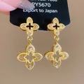 Close-up of gold clover earrings with textured finish and silver needle pins - Textured Quatrefoil Style (36#) / Gold