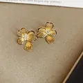 Elegant Korean style 18K gold plated hollow flower stud earrings with zircon center - Hollowed Out Rhinestone Petal Style (44#) / Gold
