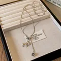 Elegant silver necklace featuring a zircon-encrusted horse pendant and flower charm - Horse Pendant Long Chain / Silver