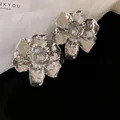 Elegant silver metallic flower stud earrings with a textured 3D floral design - Hammered Silver Flower Style (28#) / Silver