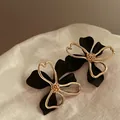 Elegant black and gold flower stud earrings in Korean style on white fabric background. - Black And Gold Patchwork Flower Style (7#) / Black