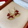 Detailed view of exquisite red enamel winged rocking horse earrings with zircons - Rocking Horse Shape (WE5623) / Red