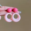Stylish two-tone pink resin round stud earrings featuring hollow geometric circle drops - No.8 925 Silver Needle Pink