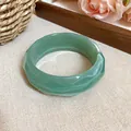 Wavy faceted pale green acrylic bangle bracelet with a translucent jade-like finish - Wave Cut Acrylic Bangle / Light Green