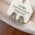 Detailed view of silver gourd-shaped clip-on earrings with shimmering zircon stones - Clip-On Earrings / Silver