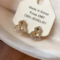 Detail view of 18k gold-plated gourd clip-on earrings with shimmering zircons. - Clip-On Earrings / Gold