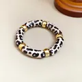 Detalle de la pulsera retro de acrílico con estampado de leopardo y piezas doradas - Rosa y Negro