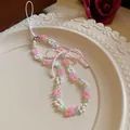 Handmade pastel beaded flower phone charm accessory featuring a cute pink beaded bow - Phone Chain / Pink-White