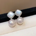 Close-up detail of elegant silver rhombus shell earrings with large dangling lavender pearls - Silver