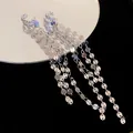 Close-up of silver three-layer geometric tassel clip-on earrings with metallic luster. - Style 6 Sequin Tassel / Silver