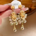 Elegant floral chandelier earrings with pearls and crystals in a peach gold finish. - Streaming Flower Tassel (8# 925 Sterling Silver Earring Post-Gold) / Yellow