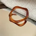 Stylish amber resin geometric bangle with unique wavy design and marbled texture - Style 42 / Brown