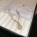 Elegant gold-plated pearl necklace featuring a large iridescent teardrop zircon pendant - Water Drop Zirconia Spliced Pearl Necklace / White