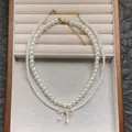 Elegant double-layer pearl necklace with sparkling zircon bow pendant and gold plating - Double Layer Zirconia Bowknot Pearl Necklace / White
