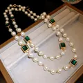 Elegant gold plated pearl necklace with emerald green square zirconia accents. - Emerald Zirconia Pearl Necklace / Gold-Green-White