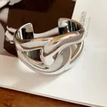 Chunky silver metallic finish acrylic cuff bracelet with unique twisted hollow design - Cross Design / Silver