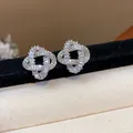 Close-up of luxury 18k gold plated silver stud earrings with intertwined zircon detail - Twined Knot Style / Silver