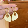 Elegant geometric drop earrings featuring gold metal loops and cream acrylic pendants. - 87# Silver Needle - Gold - Yellow