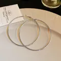 Elegant large silver hoop earrings on a cream-colored ceramic jewelry plate - 7cm Silver Post Hoop Style (27#) / Silver