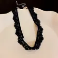 Close-up of elegant black lace choker necklace with vintage scalloped edges - Simple Black Wave Pattern Style