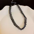 Macro view of a black lace choker necklace featuring a delicate woven mesh pattern on a white plate - Black Hollow Diamond Mesh Style