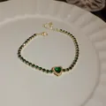 Elegant gold-plated tennis bracelet featuring a green heart stone and matching rhinestones - Heart Main Stone Style (50#)