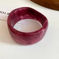 Detailed close-up view showing the rich marble pattern of a magenta resin bangle bracelet - Pink Purple