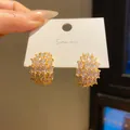 Macro view of vintage gold-tone oval earrings encrusted with sparkling marquise crystals - Oval Cluster Style (5) / Gold
