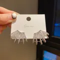 Detail view of silver earrings with sparkling stones on a white card holder. - Multi-Layer Radiant Fan Style (14) / Silver