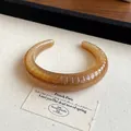 Handmade amber marbled resin cuff bracelet featuring irregular geometric ribbed texture - Style 40