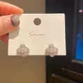 Elegant clover stud earrings with sparkling cubic zirconia on a white display card. - Clover Full Rhinestone Style (32) / Silver