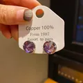 Elegant purple round faceted crystal stud earrings presented on a white display card. - Round Faceted Gemstone (36) / Silver with Purple