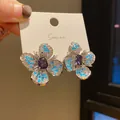 Elegant silver-toned flower stud earrings with purple center crystal and blue accents - Two-Tone Gem Flower Style (50) / Silver Blue Purple