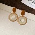Detailed view of vintage ethnic-style earrings with golden grid-woven circle design - Brown Grid (HE2526) / Silver Earring Post Style
