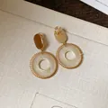Detailed view of vintage gold-tone earrings with circular mesh woven drop design - Brown Grid (HE2526) / Clip-on Earrings