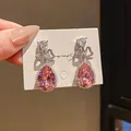 Elegant pink pear-shaped drop earrings with a sparkling rhinestone bow design on a display card. - Bowknot Pink Teardrop (58) / Silver Plated Pink