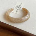Elegant marbled resin cuff bracelet with textured ridges in a warm beige finish - Style 52 - Light Coffee Color