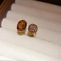 Detailed view of vintage gold open ring featuring oval amber stone and crystal ball - Gold Brown