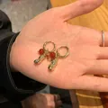 Unique gold hoop earrings featuring red glass beads and realistic peanut-shaped charms - Peanut Hoop Earrings / Gold with Red