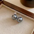 Close-up of vintage dark grey pearl stud earrings with zircon in a wooden jewelry box - Pearl Zirconia Style (HE14524) / Gray