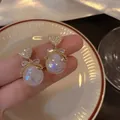 Detailed view of iridescent mermaid pearl earrings with crystal-encrusted heart and bow - 16# Gold Heart Bow Mermaid Pearl