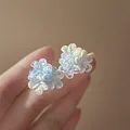 Elegant light blue resin flower stud earrings with shimmery finish and silver needle. - Blue