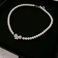Elegant white pearl choker necklace with a sparkling zirconia butterfly pendant - 21# Necklace