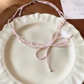 Elegant pink beaded bow necklace with white pearls, delicate SKU variant product shot - Necklace Style 28