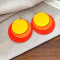 Macro view of layered colorful circular wooden drop earrings with gold hook closure - Hook Style / Yellow Orange Red Gradient