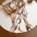 Close-up detail of a bohemian style feather headband with wooden beads and tassels. - Feather Hairband (HH8917) / Coffee & White