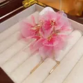 Detail view of elegant pink mesh flower earrings with gold chains and metal pendants - Flower Mesh Drop Earrings (HE20284) / Pink