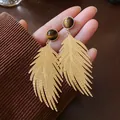 Close-up of gold leaf-shaped earrings with artificial tiger eye stone - Leaf Style Drop Earrings (HE24090) / Gold Brown